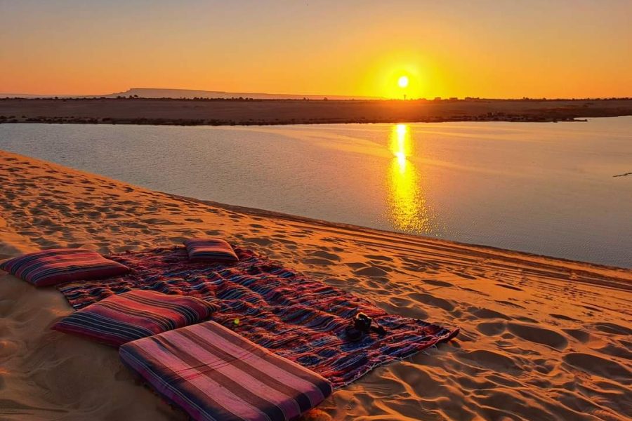 Sunset over desert with picnic setup